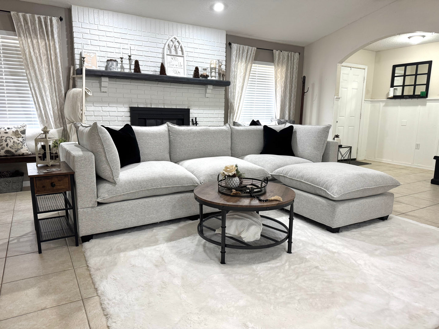 Modern living room with a sofa, coffee table, and decorative items.
