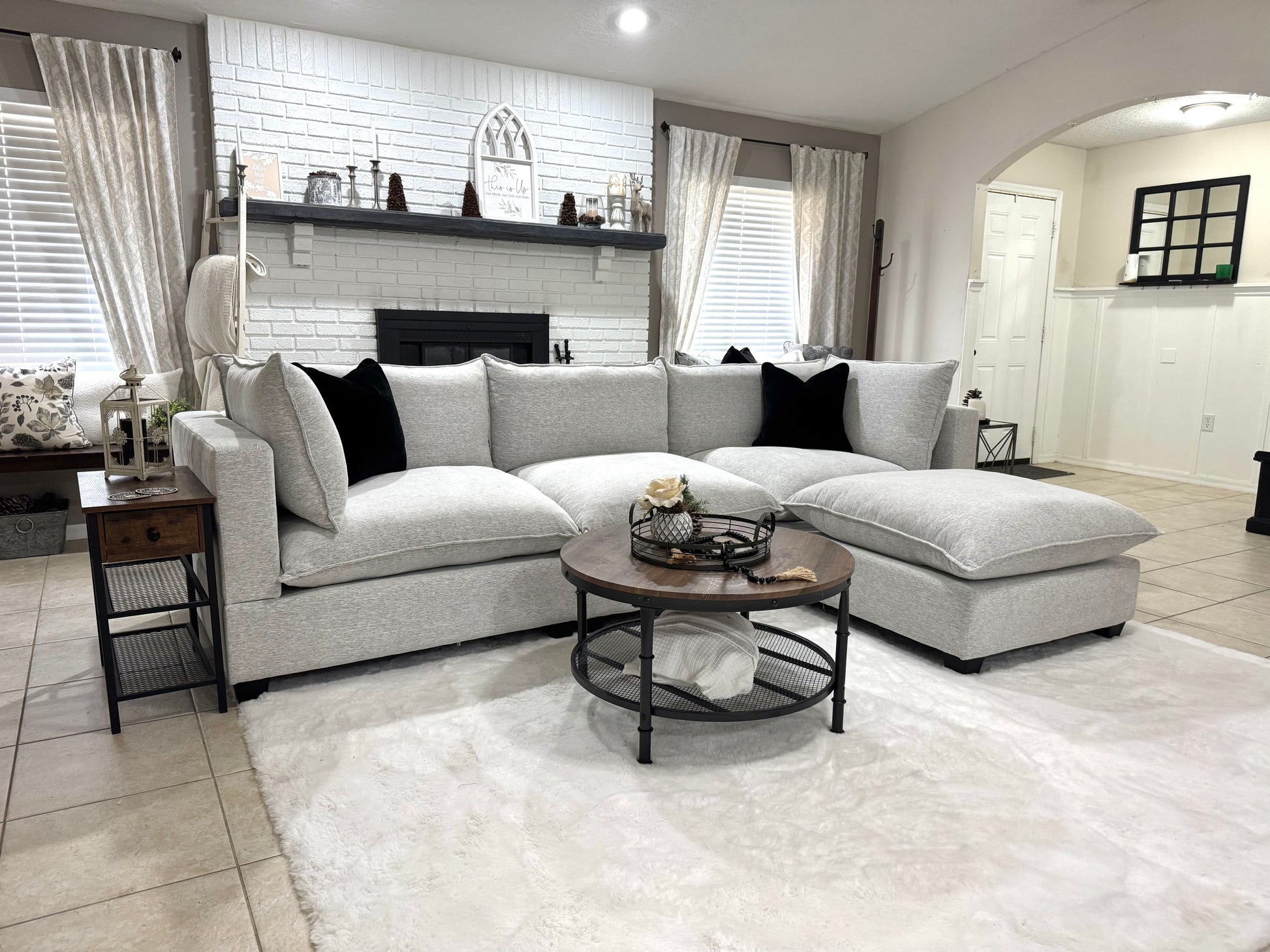 Modern living room with a sofa, coffee table, and decorative items.