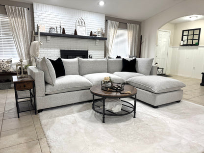 Modern living room with a sofa, coffee table, and decorative items.