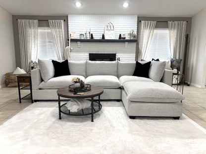 Modern living room with a sofa, coffee table, and decorative items.
