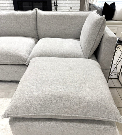 Sectional sofa with ottoman in a living room setting