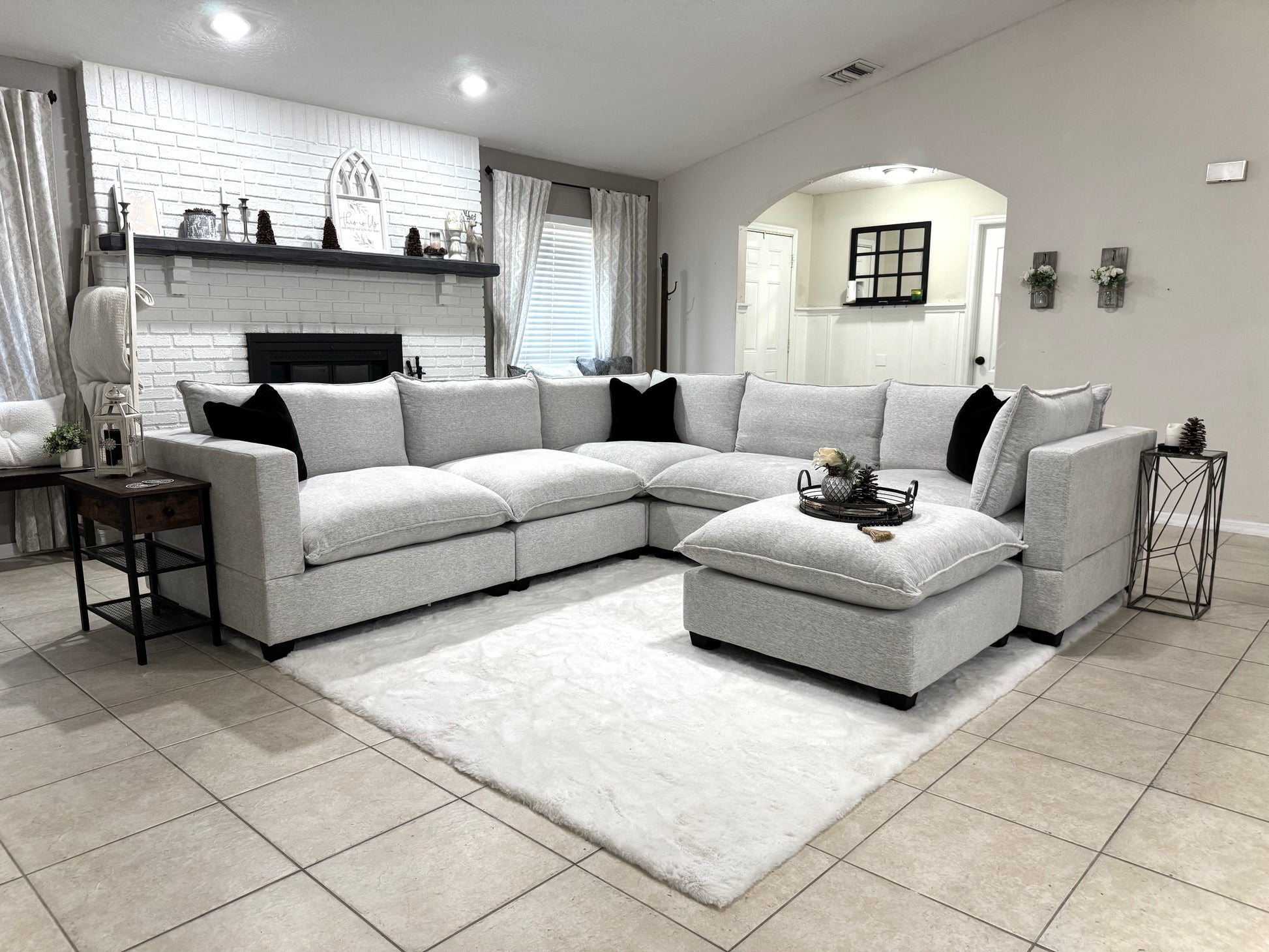 Modern living room with a sectional sofa, coffee table, and decorative items.