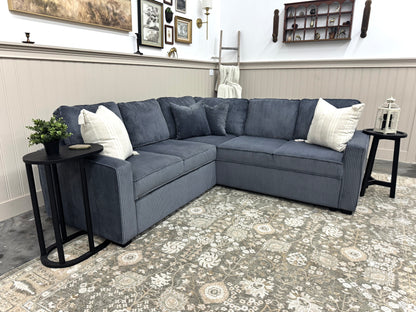 Sectional sofa in a living room with decorative pillows and side tables.