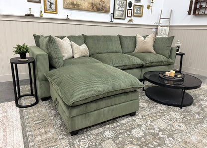 Green sofa in a living room setting with decorative elements.
